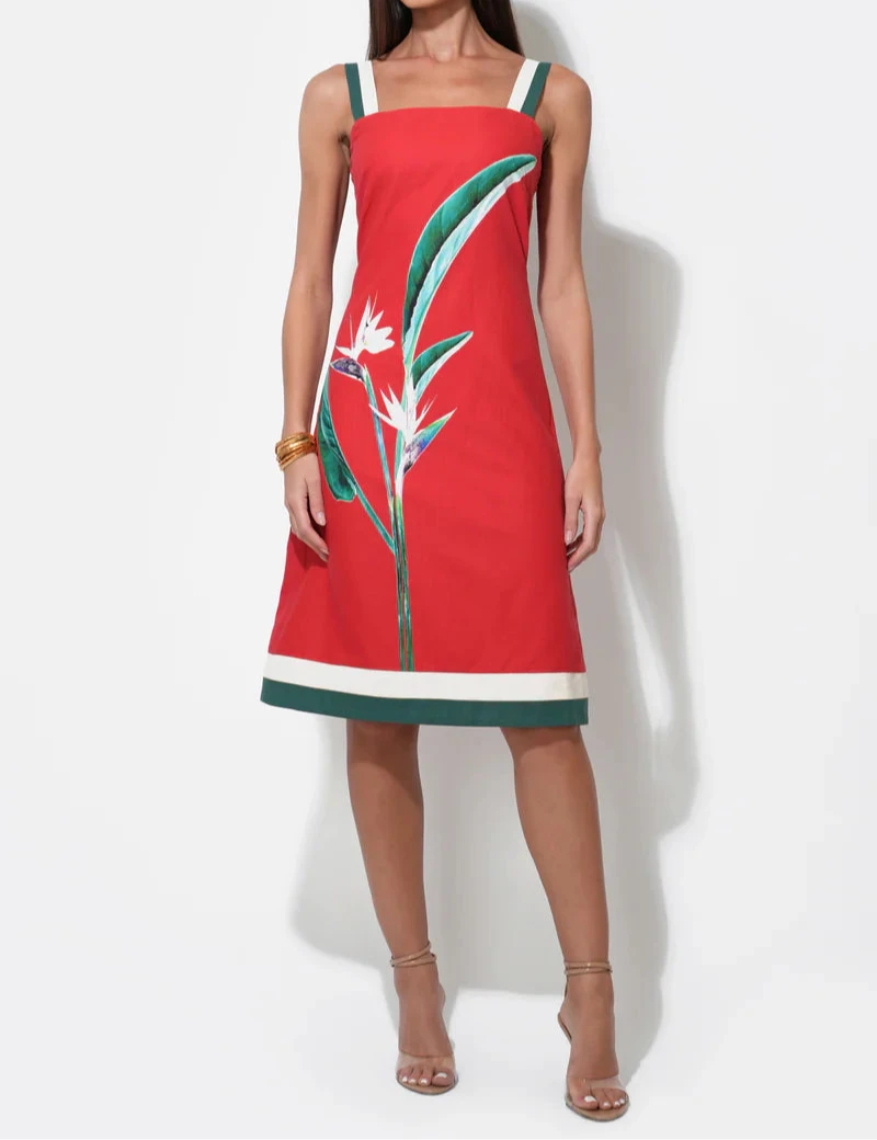 Woman wearing a red dress with floral Birds of Paradise design midi sleeveless dress