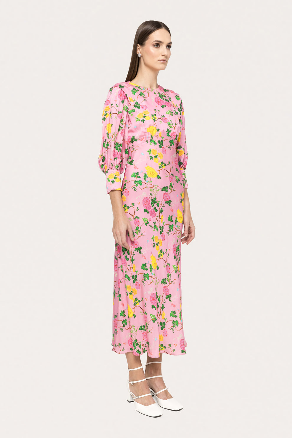 Side profile of the Nissa pink floral viscose midi dress, highlighting its mid-calf length and elegant silhouette.