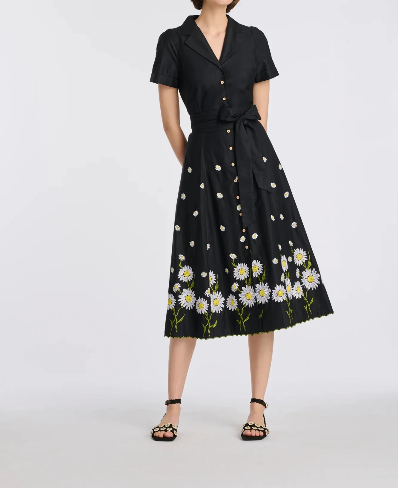 Full-length view of black cotton midi shirt dress with floral embroidery and removable belt on model