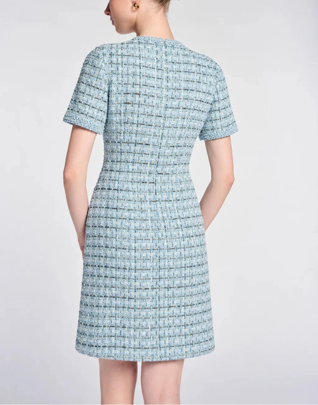 Back view of a fitted Weill Paris light blue tweed dress showing waist shaping, short sleeves and an above-knee hem.