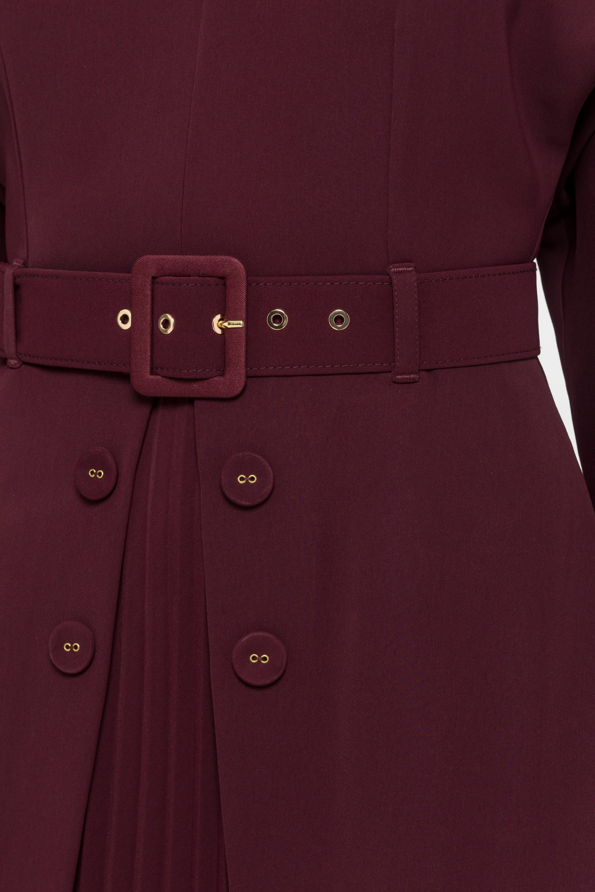 Close-up of the Bordeaux fabric-covered buckle, gold-tone belt eyelets and decorative buttons on the NISSA midi dress.