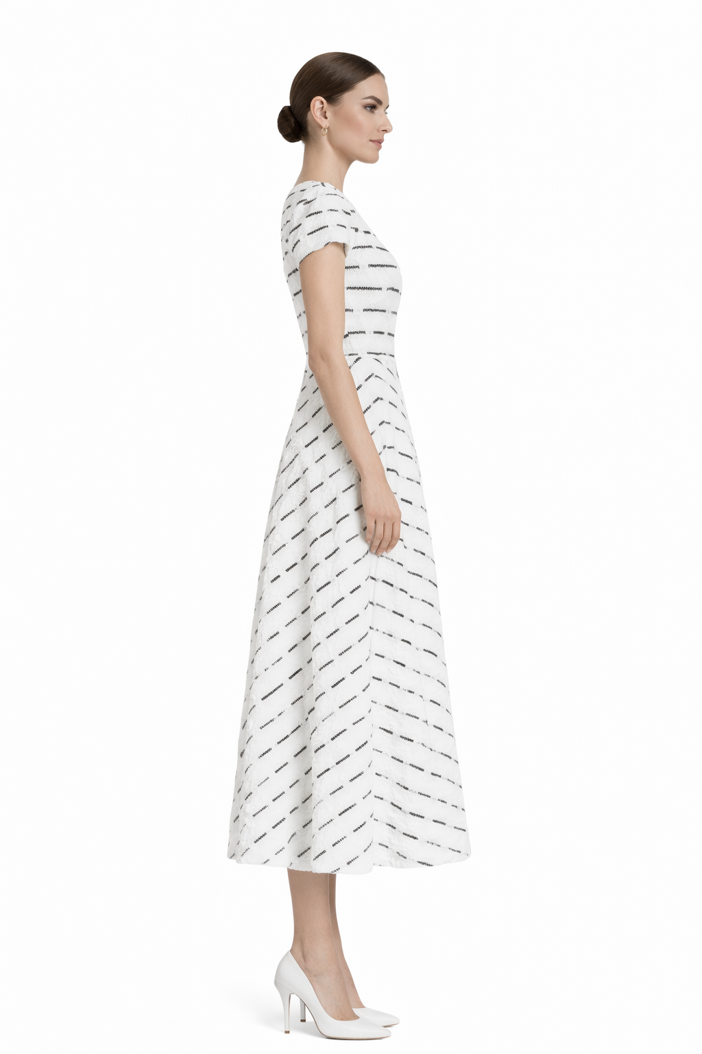 Side profile of black and white lace midi dress showing structured waist and soft A-line movement.