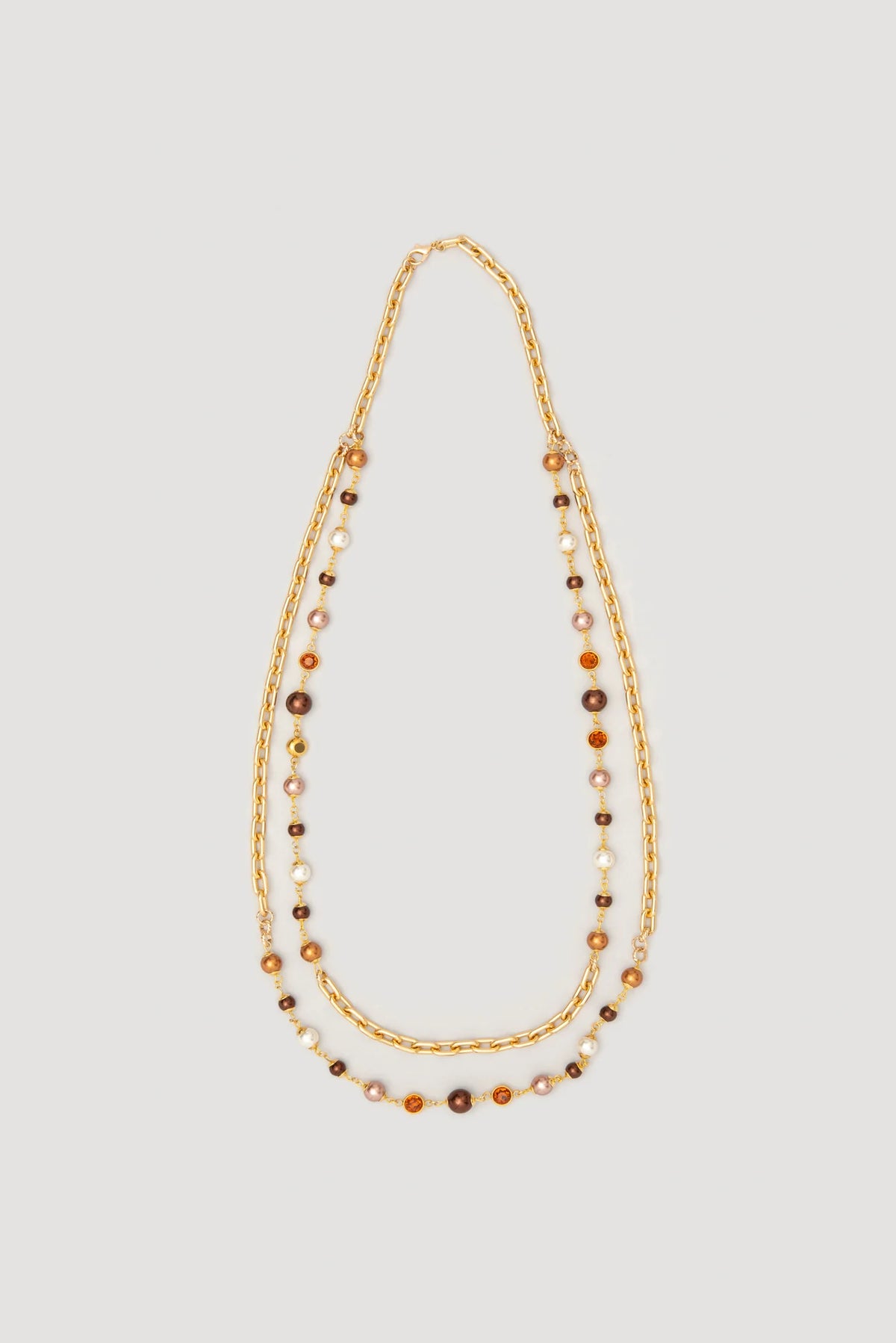 WEILL Paris double chain necklace laid flat, with gold-tone links, brown and ivory pearl-look beads and amber-colored accents.