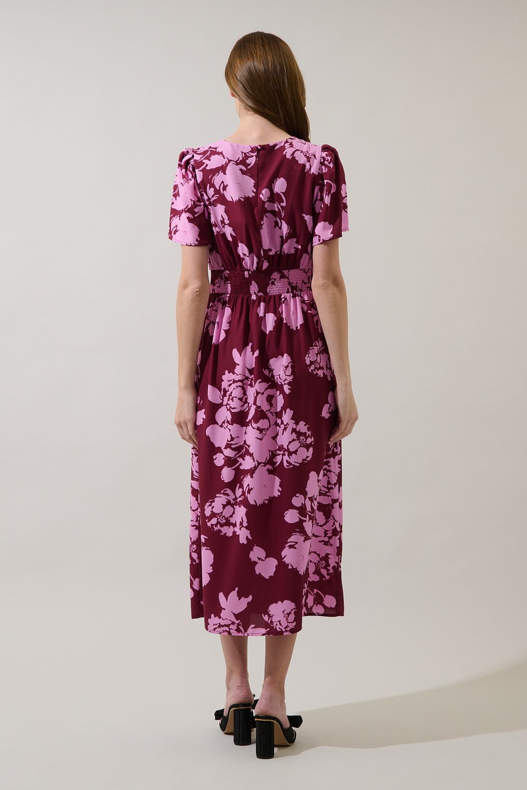 Back view of the Bloom floral midi dress showing the smocked waist, gathered bodice and short sleeves.