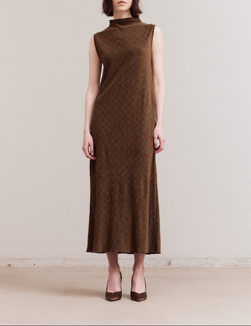 Front view of a model wearing a dark moss sleeveless crinkled velvet mock‑neck midi dress, standing against a neutral background.