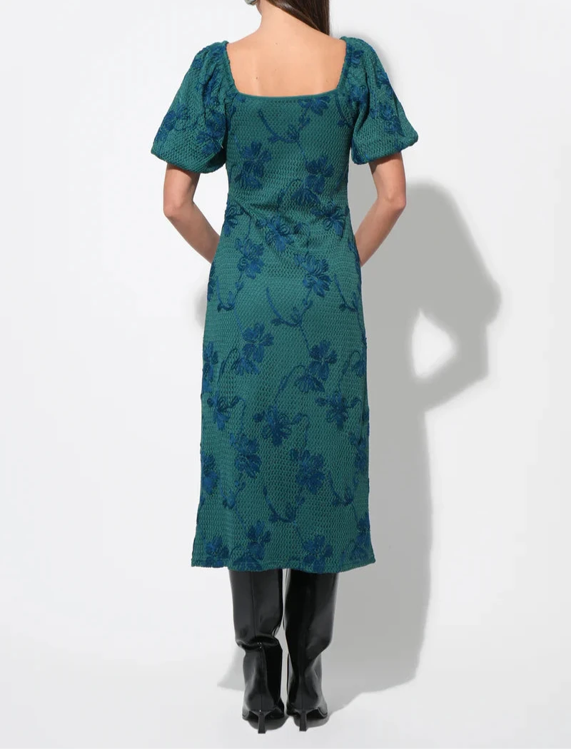 Back view of emerald floral knit midi dress with square back and straight skirt