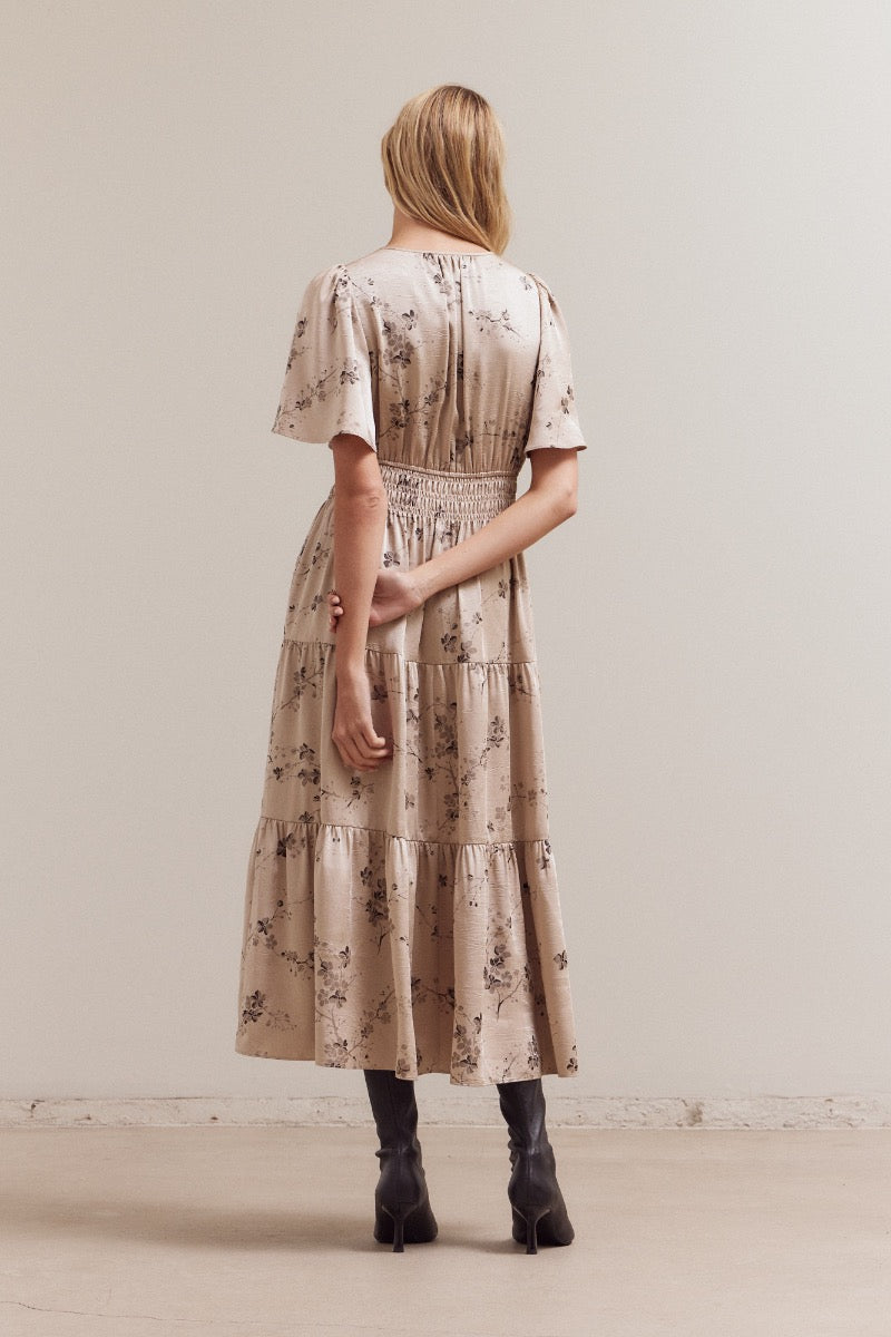 Back view of natural floral print midi dress with flutter sleeves