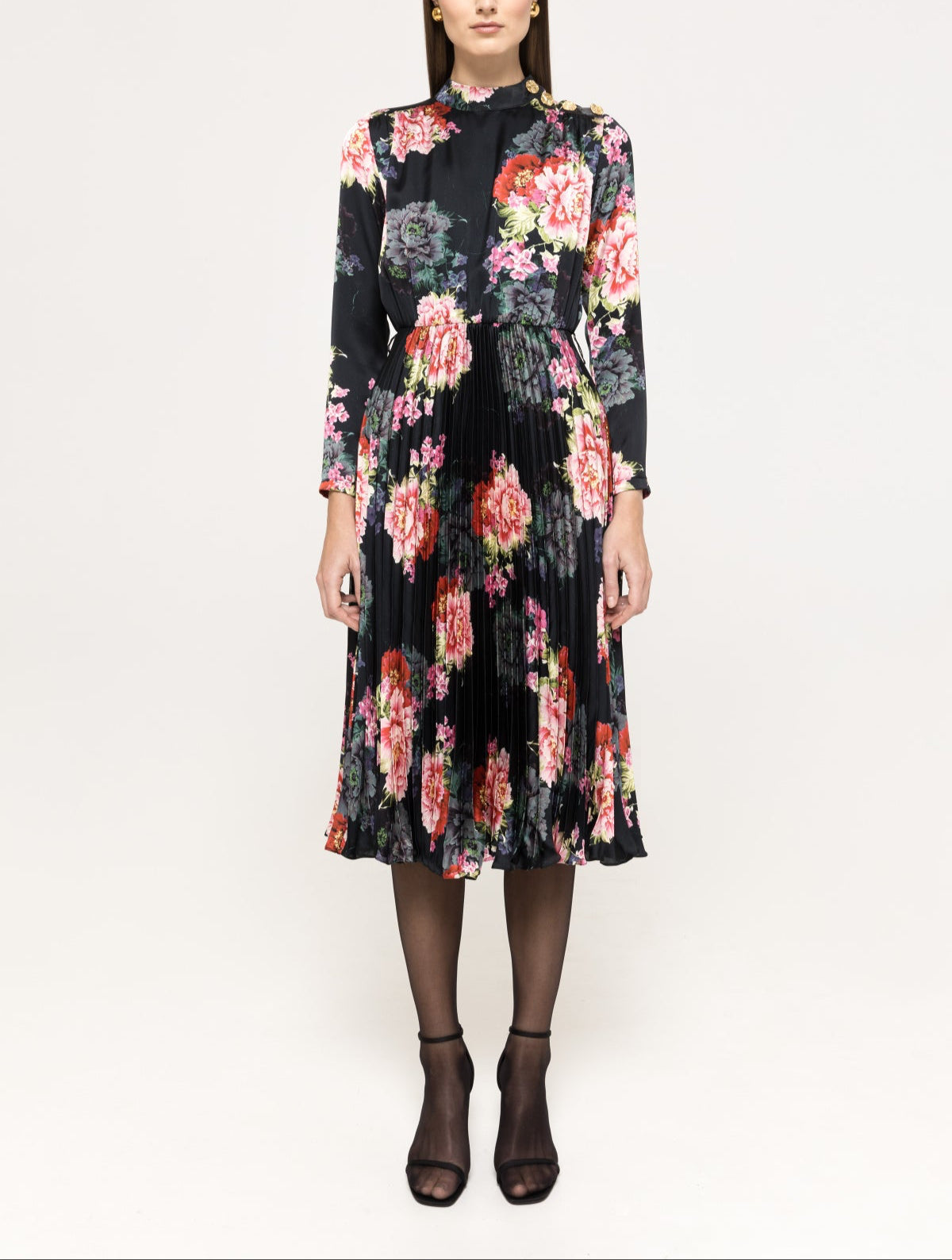 Front view of black floral pleated midi dress with mock neck, shoulder buttons and long sleeves.