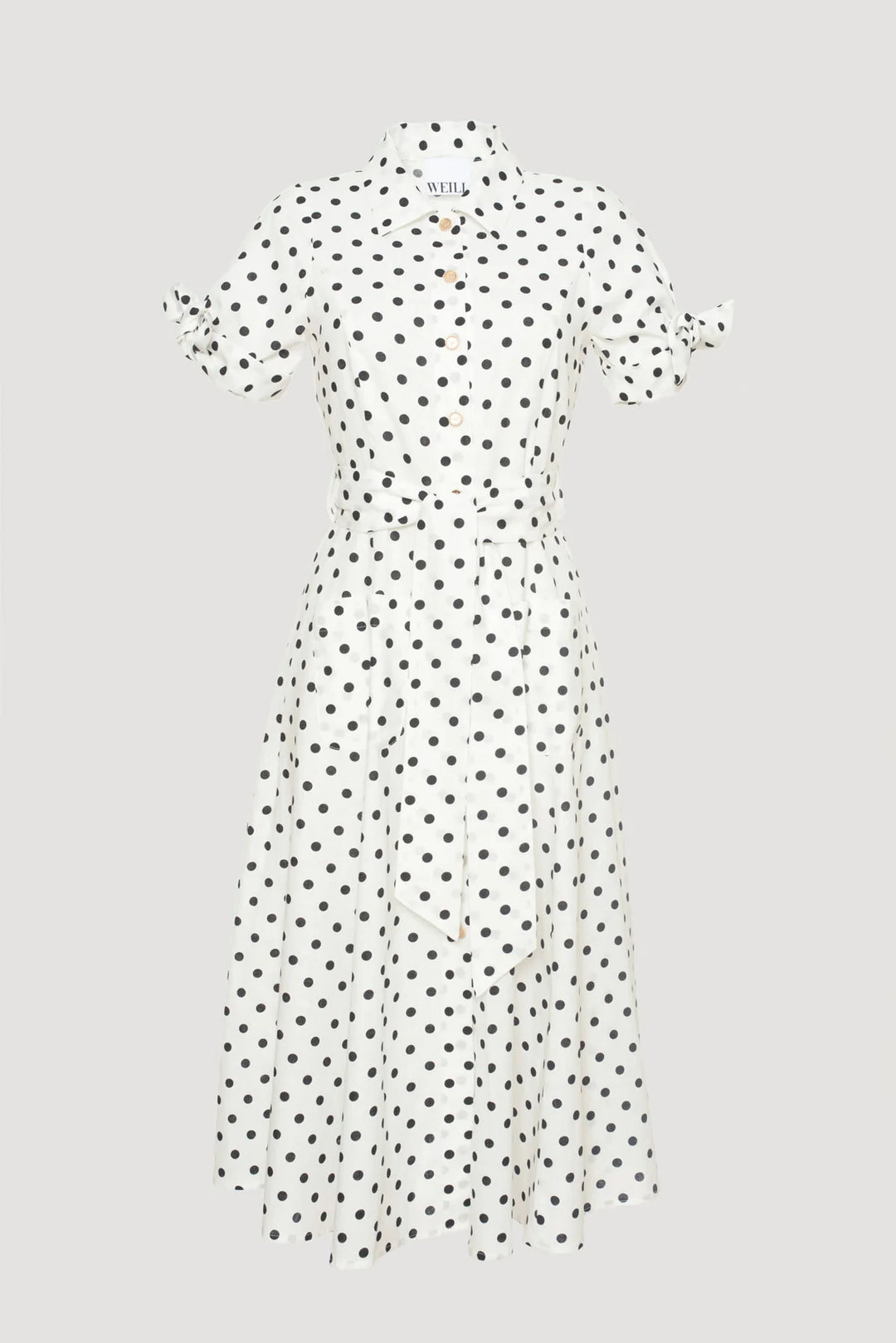 White midi-length polka dot shirt dress with black dots, collar, button-down front, and tie sleeves