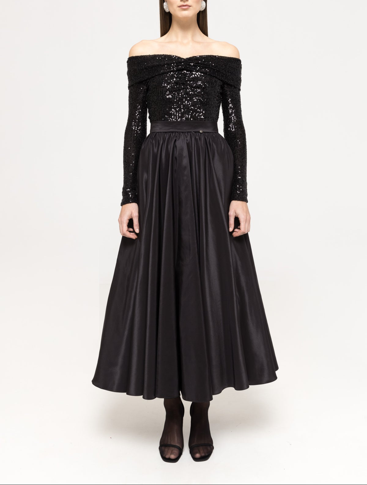 Front view of a black off‑the‑shoulder, long‑sleeve sequin‑panel taffeta midi dress with an accentuated waistband and full A‑line skirt.