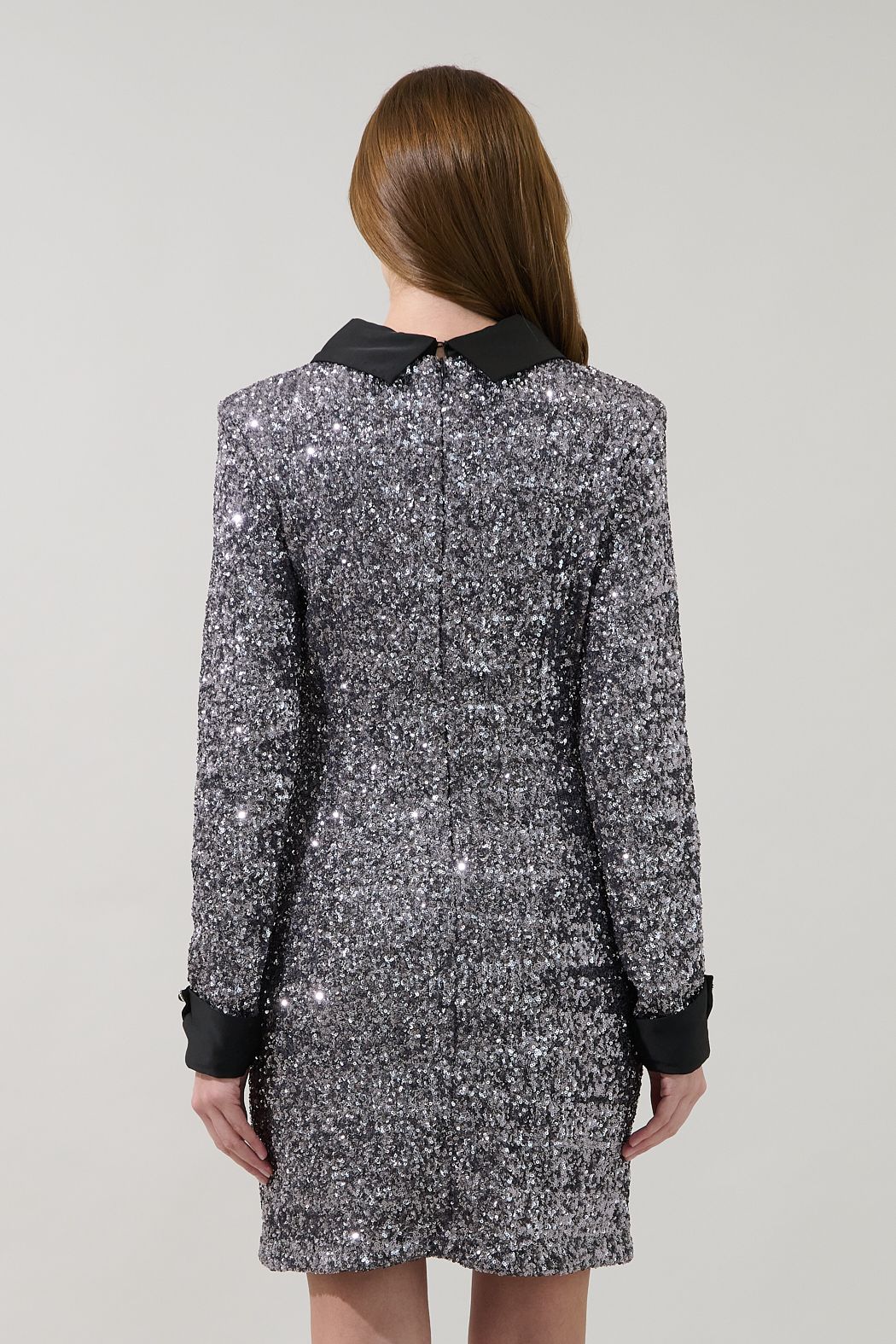Back view of the Sugarlips Alexa silver sequin shift mini dress with black collar, contrast cuffs and straight hem.