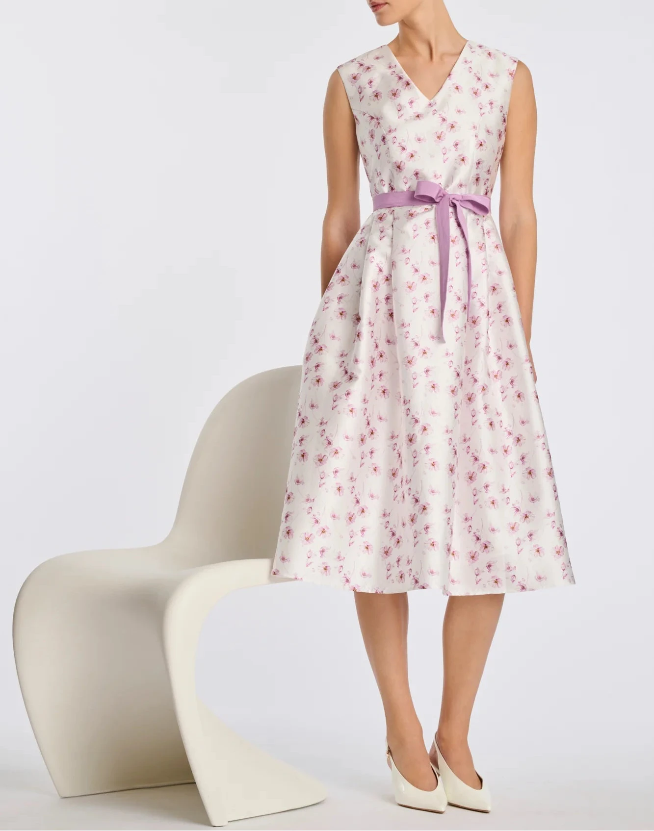 Floral taffeta midi wedding guest dress with pink floral print, V-neck, and lilac belt on model