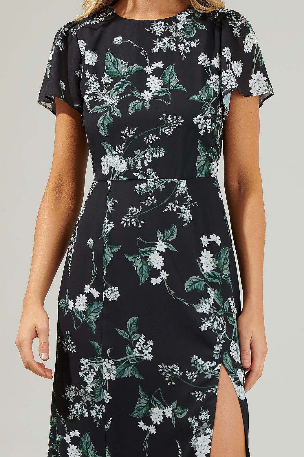 Close-up of white flowers and green foliage on the Angelonia dress, with a round neckline and softly gathered shoulders.