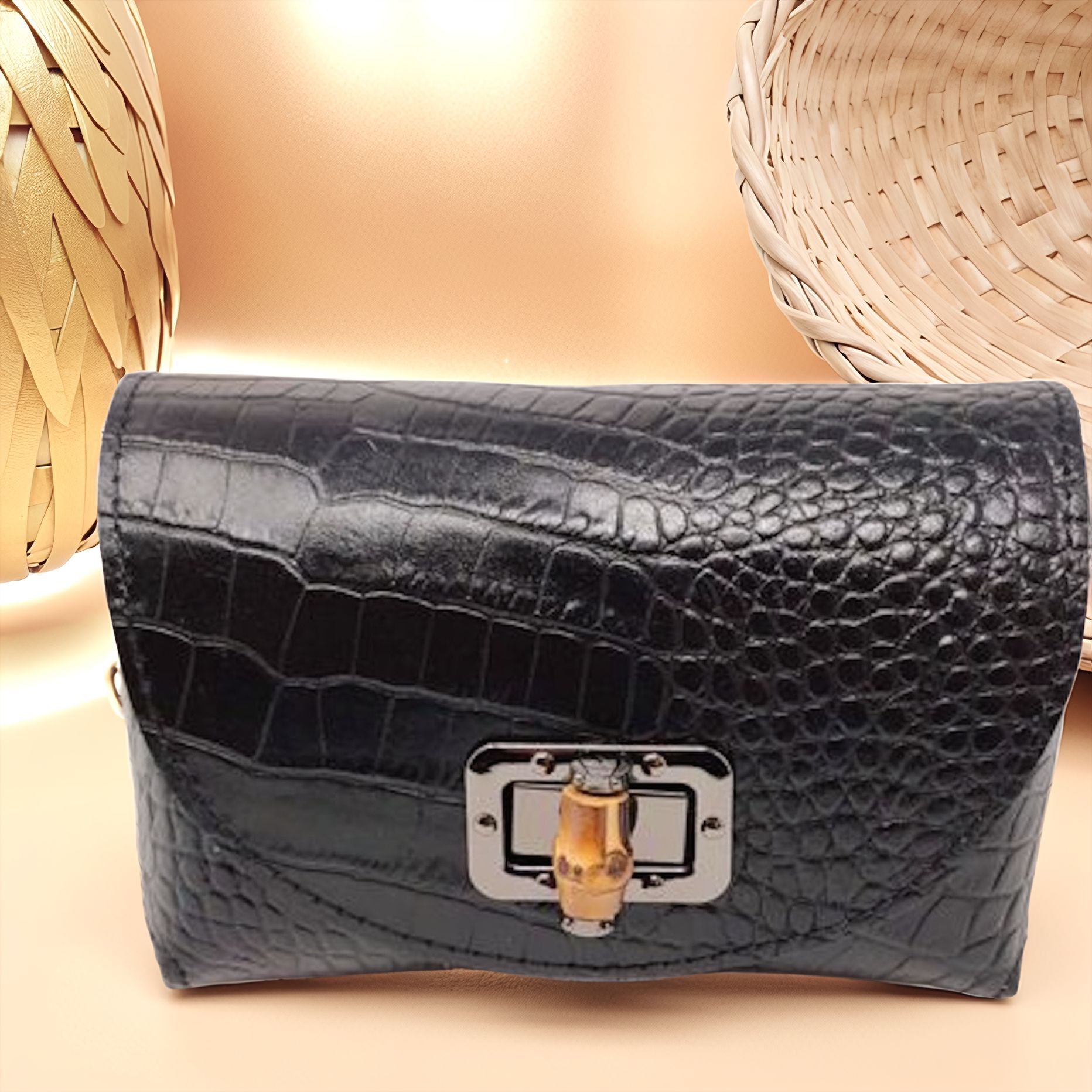 Black croc-embossed genuine leather crossbody bag with bamboo-style turn-lock and compact silhouette