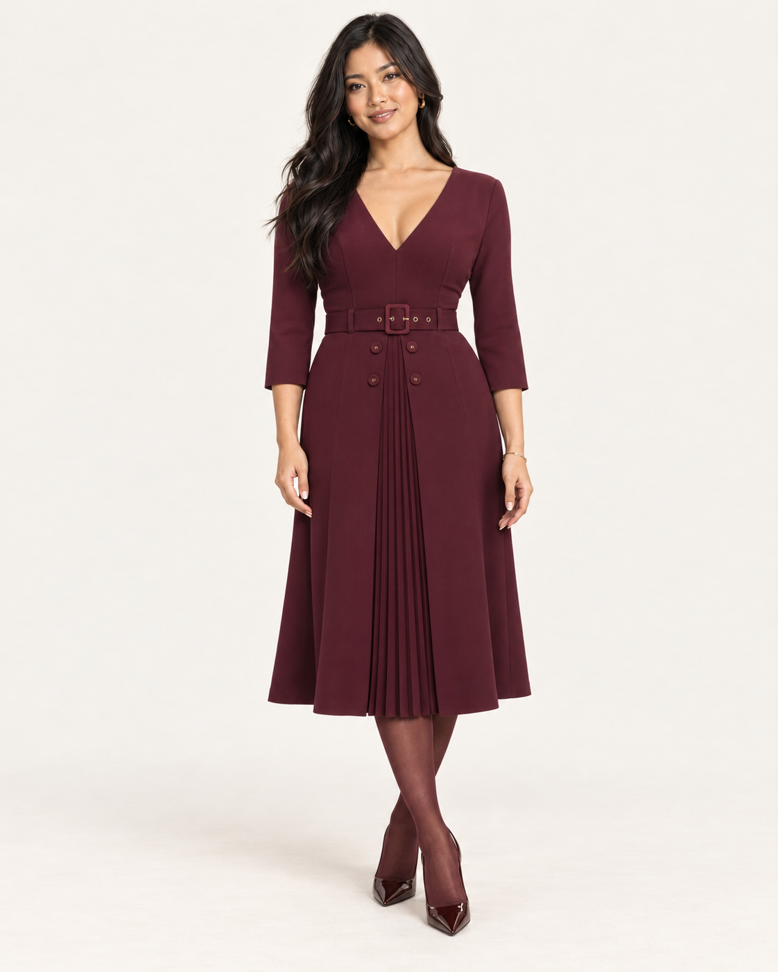 BTK Collections model wearing the NISSA burgundy belted midi dress with four buttons and a pleated front.