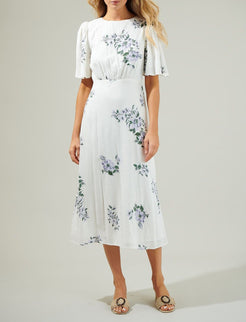 Front view of the Porto Floral Smocked Midi Dress by Sugarlips in white with purple florals