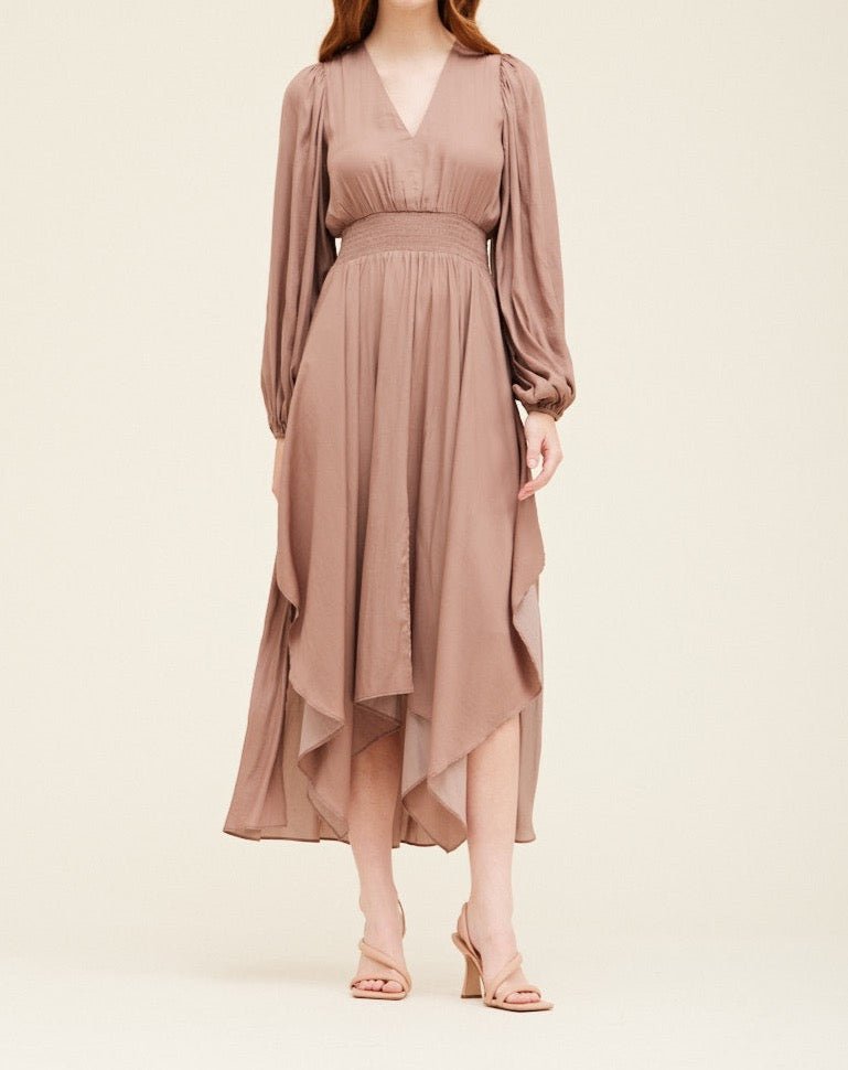 Dusty orchid satin maxi dress with long sheer sleeves, V-neckline, and smocked waist, shown from the front on model.