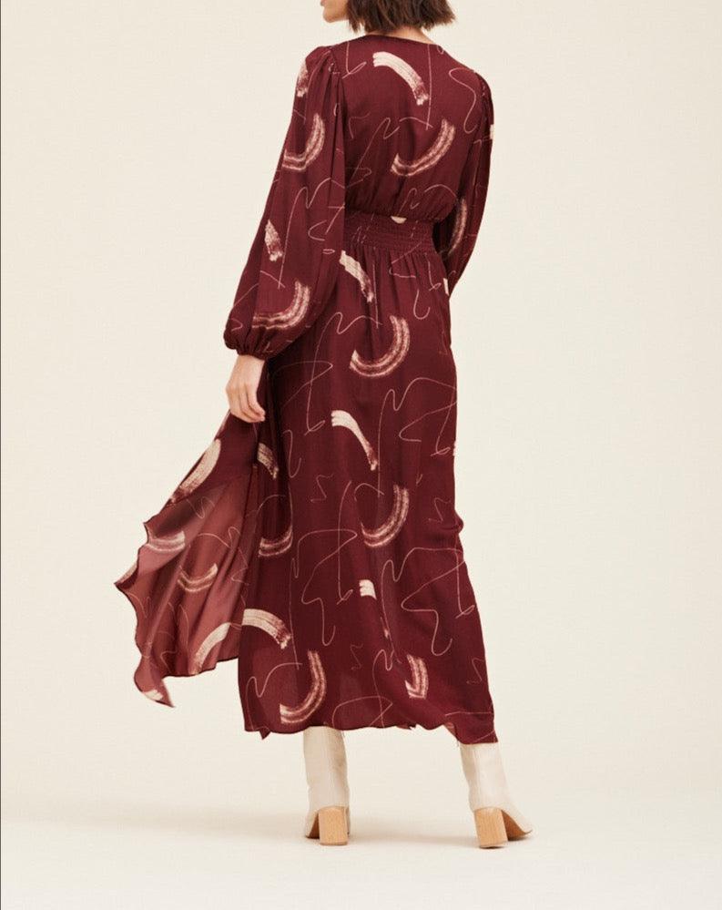 Back view of the Grade & Gather Vino satin maxi dress showing the covered back, smocked waist and flowing skirt.