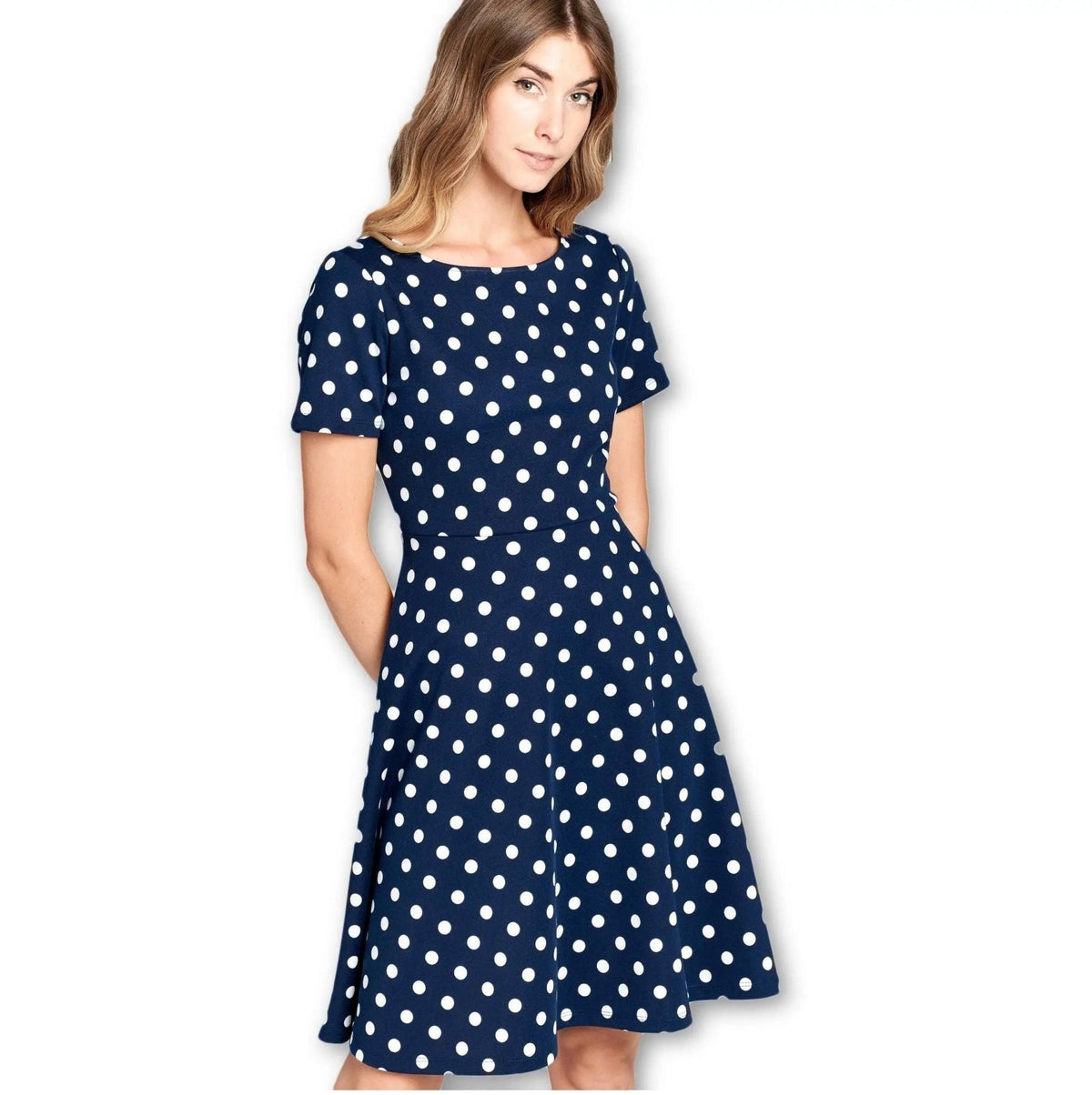 Close view of the boat neckline, short sleeves and fitted waist on the LKLUV navy polka dot dress