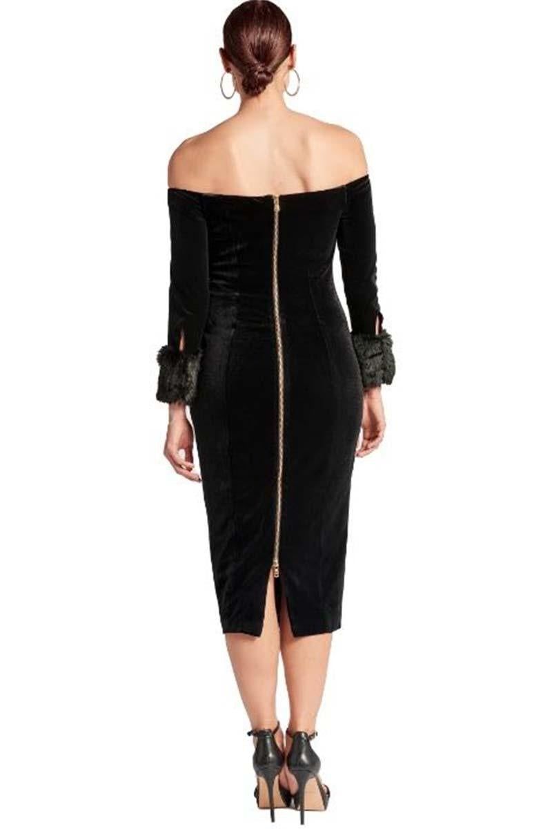 Back view of the Joia black velvet midi dress showing its exposed gold zipper, princess seams and faux-fur cuffs.