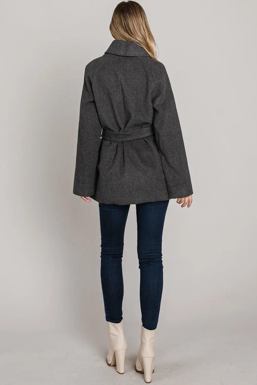 Back view of the Allie Rose charcoal wrap coat, showcasing its longline mid-thigh length, folded collar from behind, and a tie-belt detail at the back.