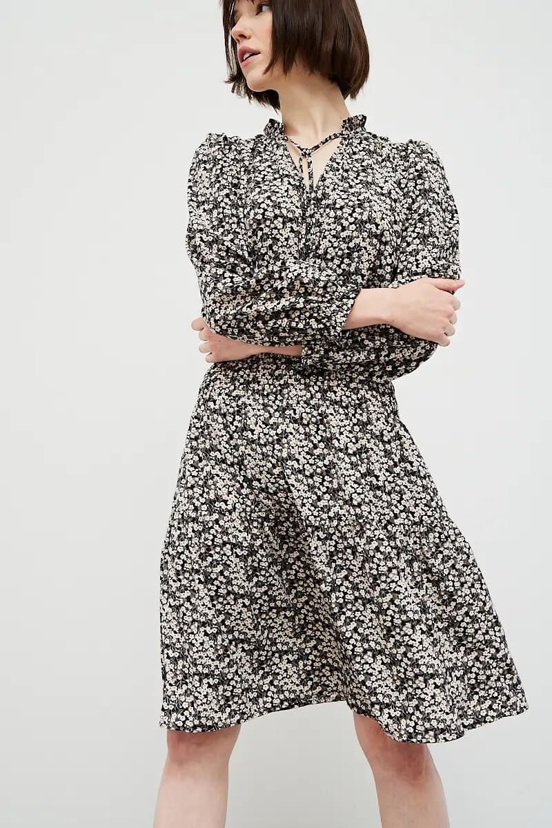 Black ditsy floral knee-length dress with puff sleeves front angled view