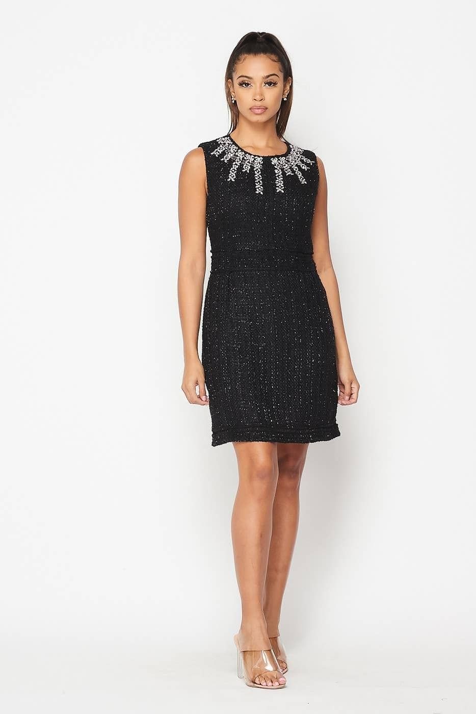 Like the Moon black sleeveless mini dress with a jeweled round neckline, defined waist and textured finish, shown from the front.