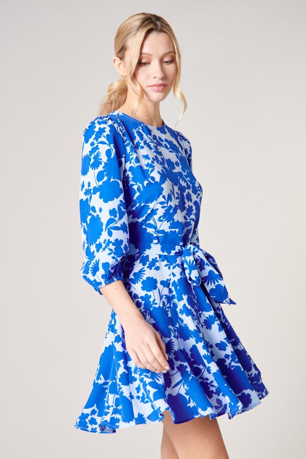 Side view of blue floral fit-and-flare mini dress with 3/4 sleeves