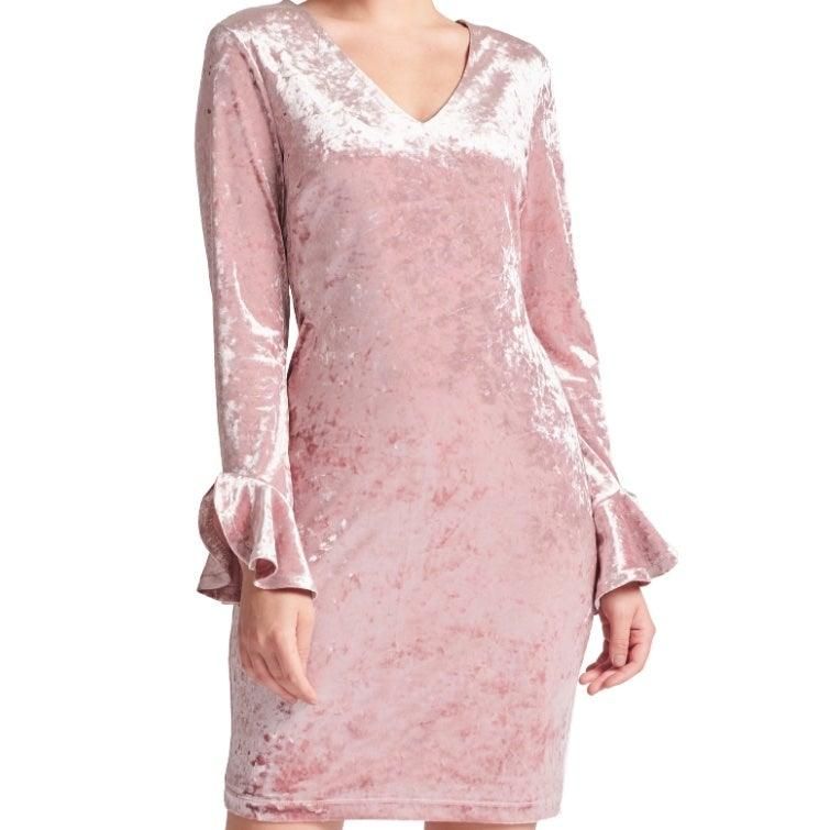Close-up of Kara's rose pink crushed velvet, V-neckline and long sleeves with small ruffled bell cuffs.