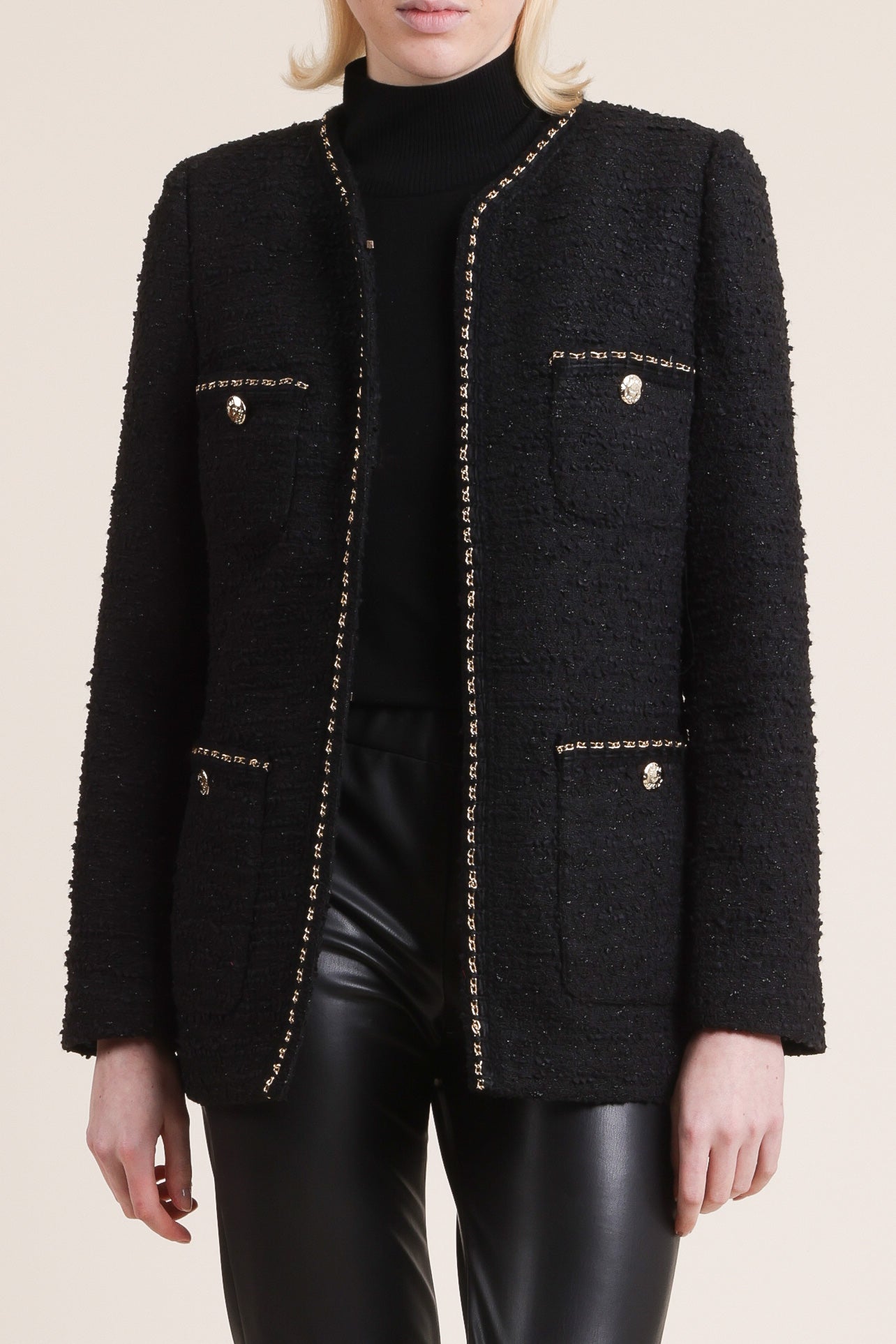 A sophisticated black tweed jacket worn by women