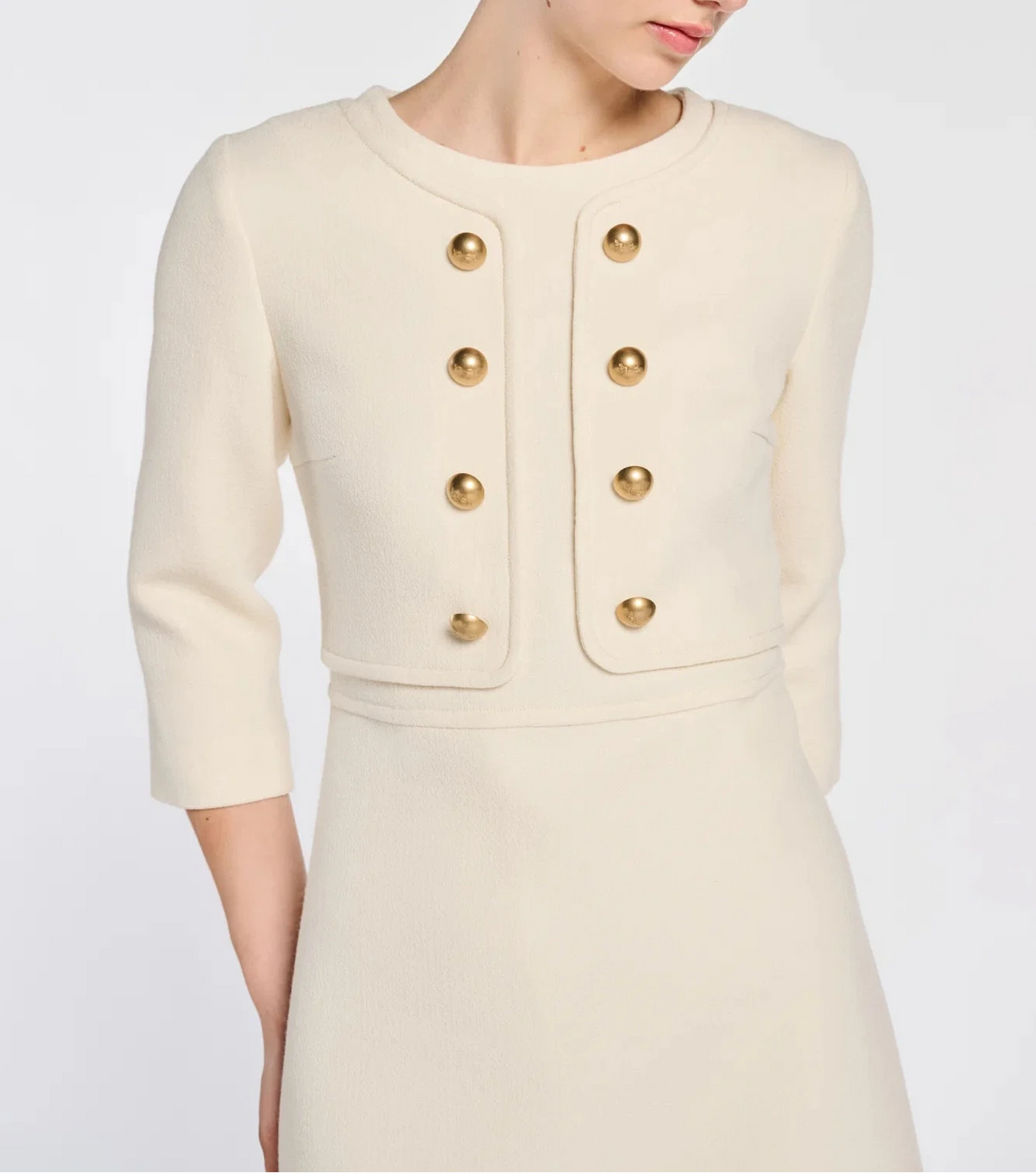 Close-up of gold-tone Weill buttons, round neckline and jacket-effect trim