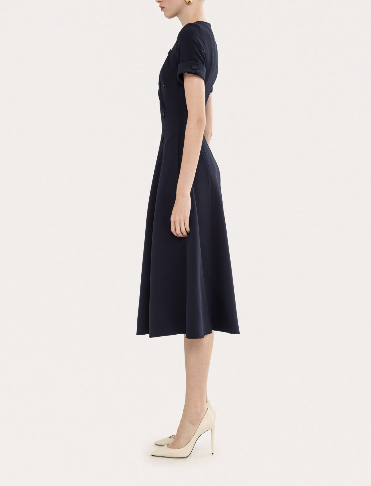 Side view of a navy short sleeve midi dress with a fitted bodice and elegant A-line skirt