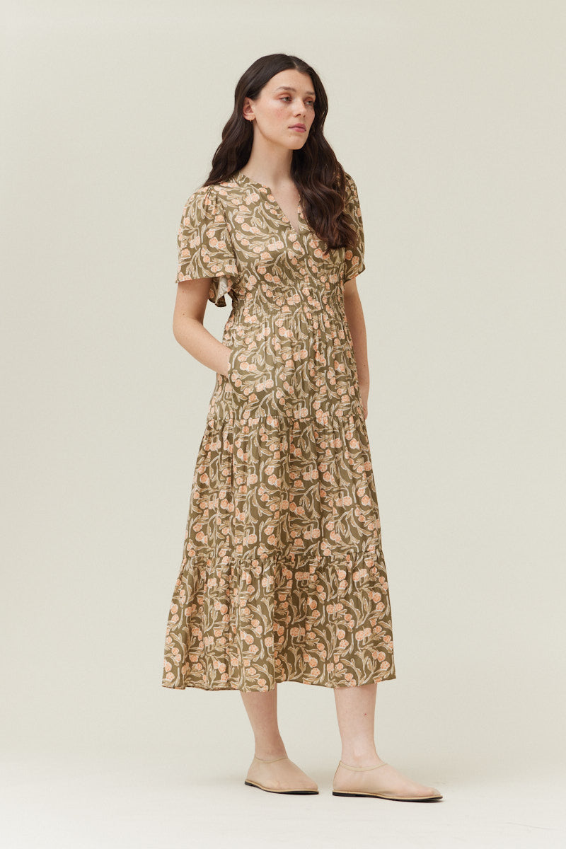Woman wearing olive floral printed midi dress