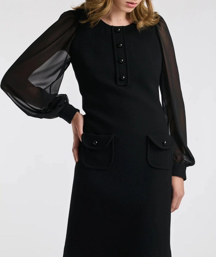 On‑model front: knee‑length black wool crêpe dress by Weill with sheer bishop sleeves, round neck and logo button placket