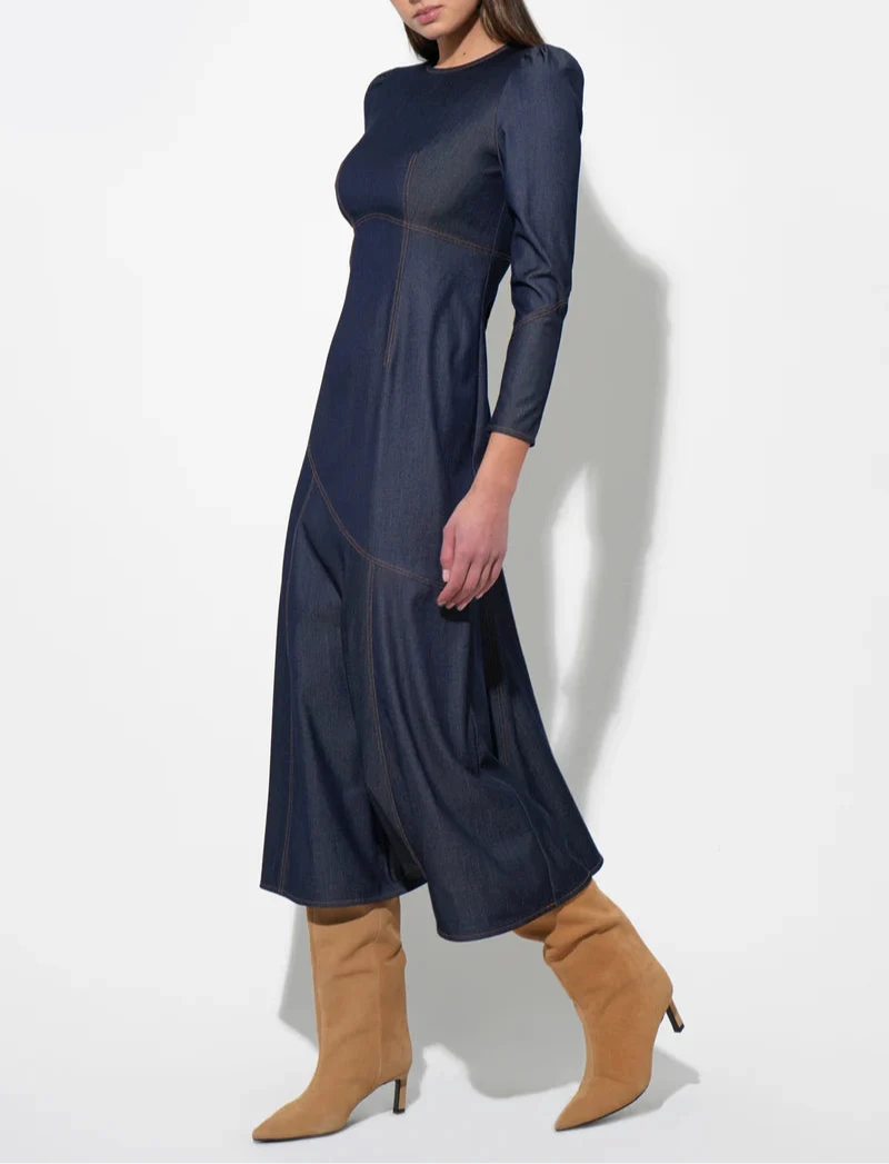 Dark indigo long‑sleeve denim midi dress with crew neck, paneled seams, and contrast topstitching