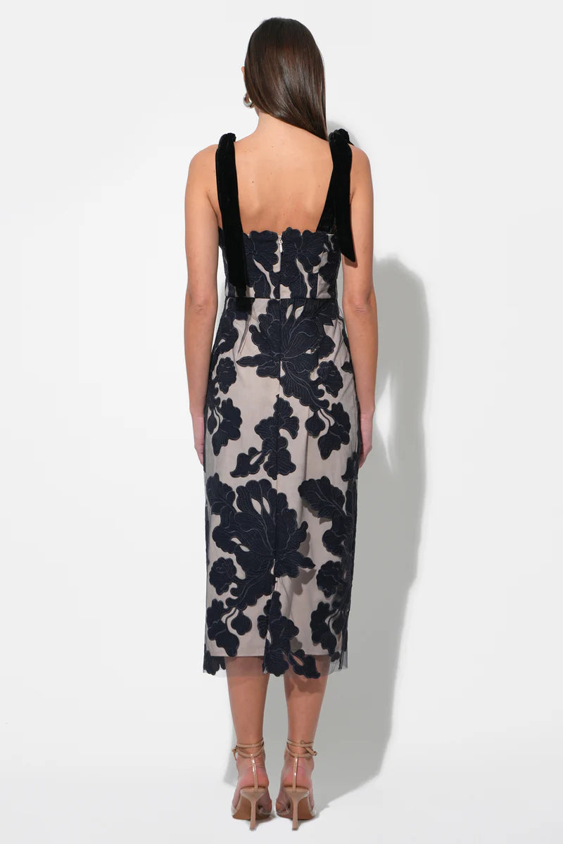 Back view of navy floral applique midi with velvet tie straps and straight back—formal evening dress at BTK COLLECTIONS.