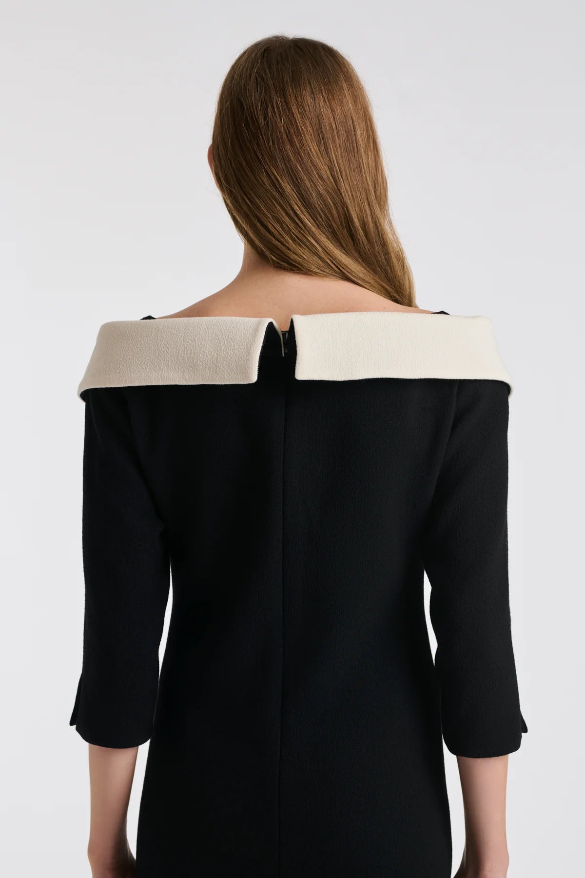 Back view of Weill Paris Bardot neck dress with wraparound ivory collar and straight knee‑length hem in black wool crepe.