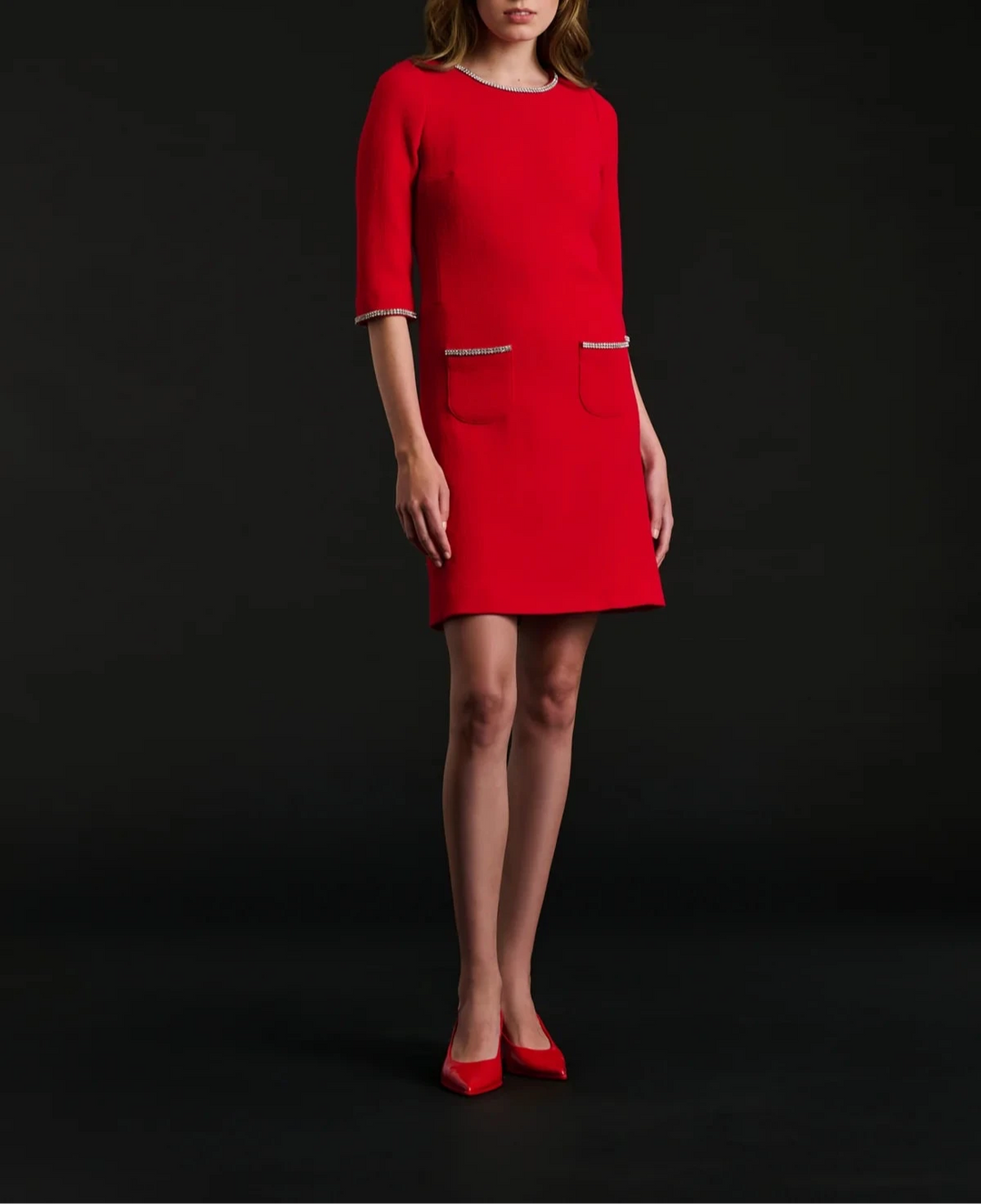 Model wearing Weill Paris red wool‑crêpe shift dress, elbow sleeves, rhinestone details, above‑the‑knee.