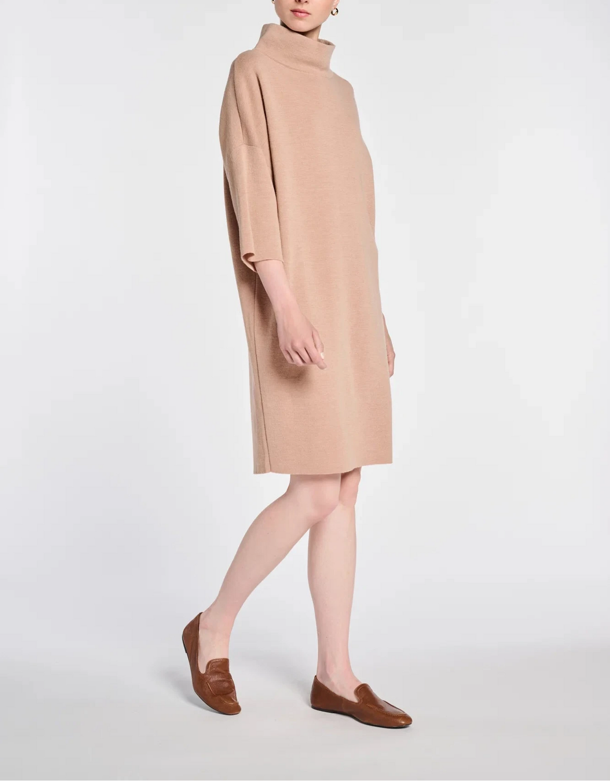 Side view of WEILL beige knee-length sweater dress with dropped shoulders and wide sleeves