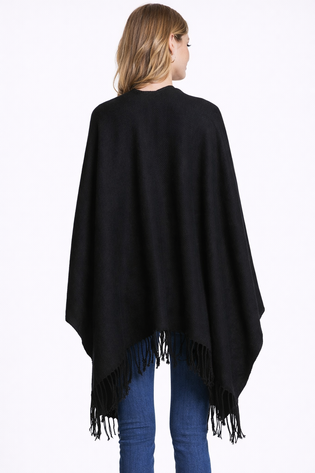 Person wearing a black poncho with fringes back view on a white background