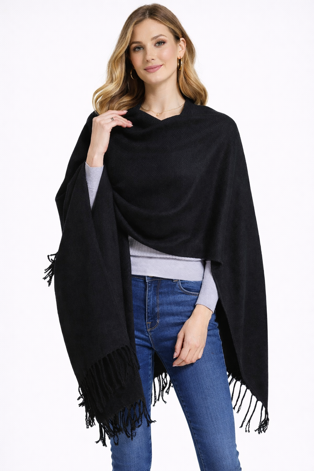 Woman wearing a black shawl with fringe on a white background