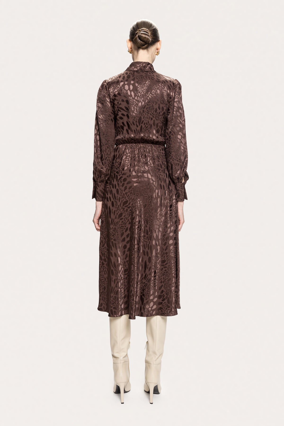 Back view of NISSA brown leopard midi dress showing a fully covered back, gathered waist and gently flared skirt.
