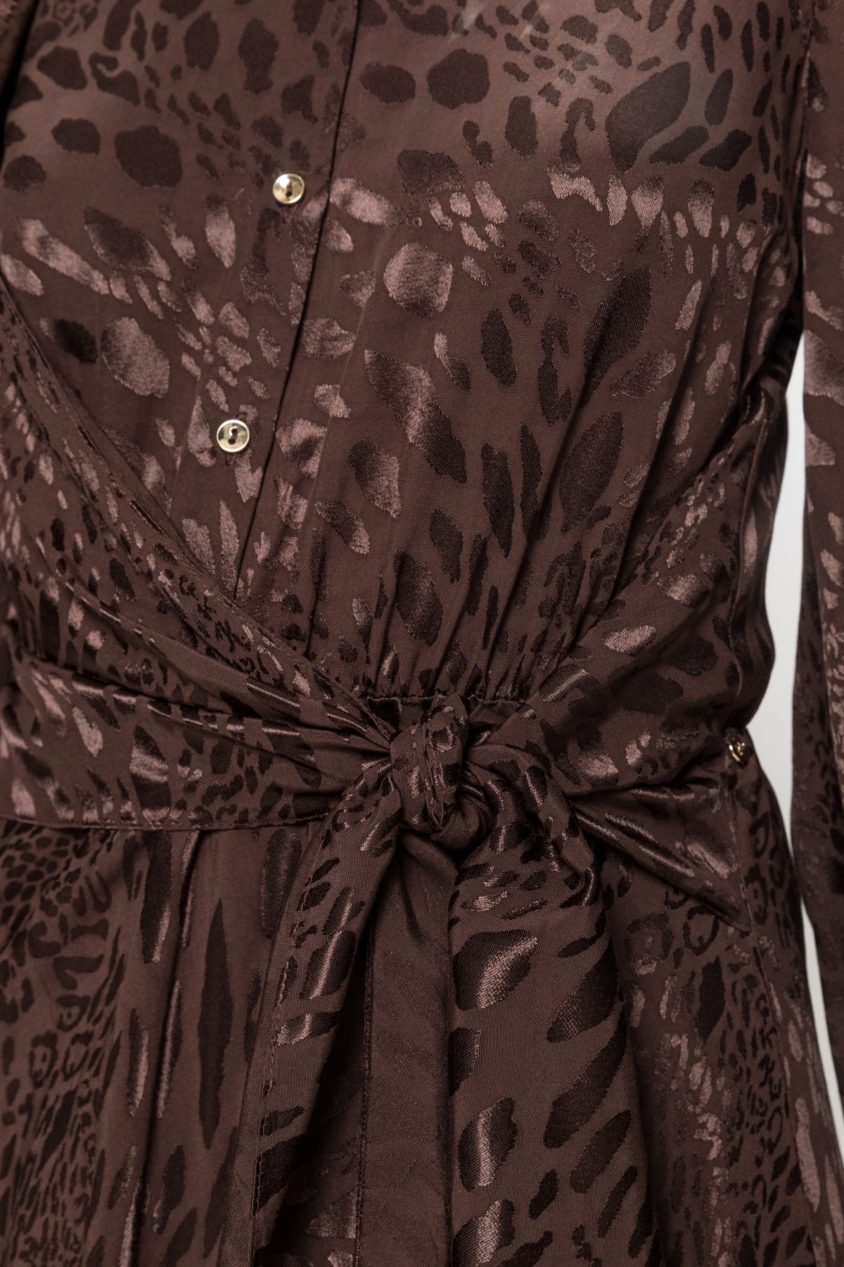 Close-up of NISSA brown leopard jacquard dress showing tonal texture, gold-tone buttons and a knotted waist tie.