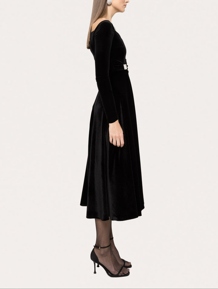 side profile of black velvet midi dress with long sleeves and flowing skirt
