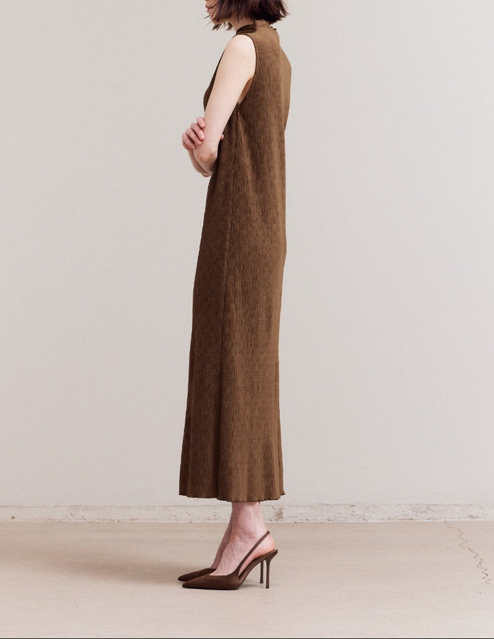 Side profile of a dark moss crinkled velvet sleeveless column dress, showing the clean straight fit and almost to ankle length.