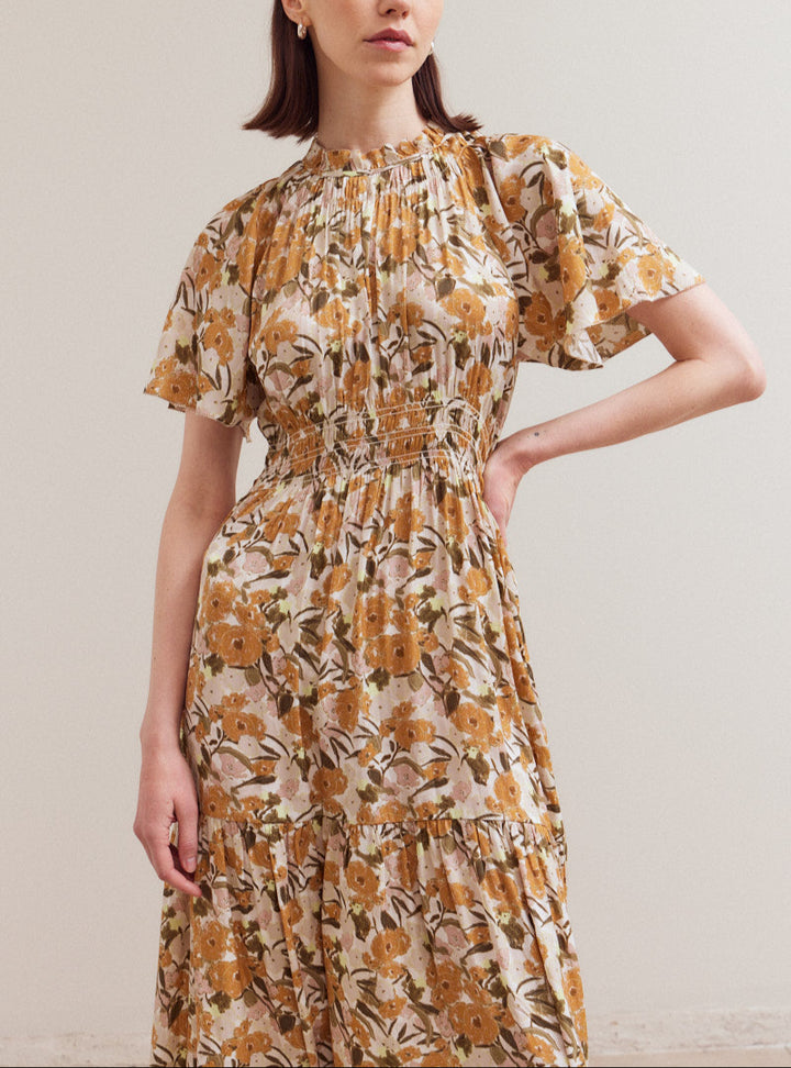Model wearing Daydream raglan sleeve floral midi dress with smocked waist and tiered skirt
