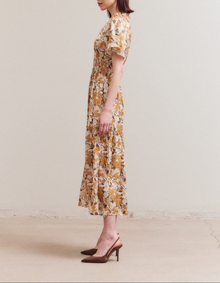Side profile of ruffled neckline floral midi dress with raglan sleeves and flowy silhouette