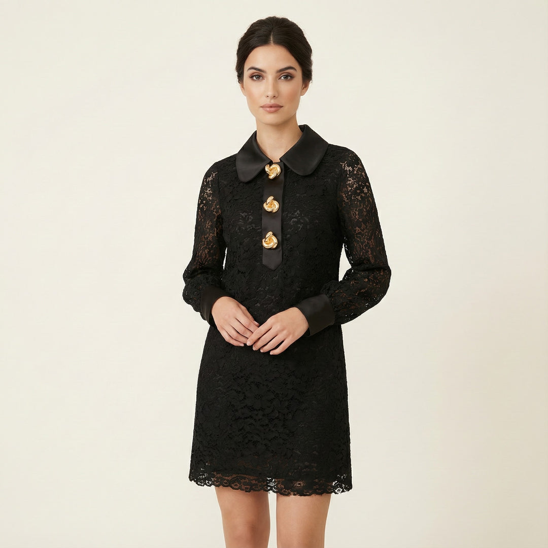 Woman wearing a black lace dress with gold buttons on a beige background