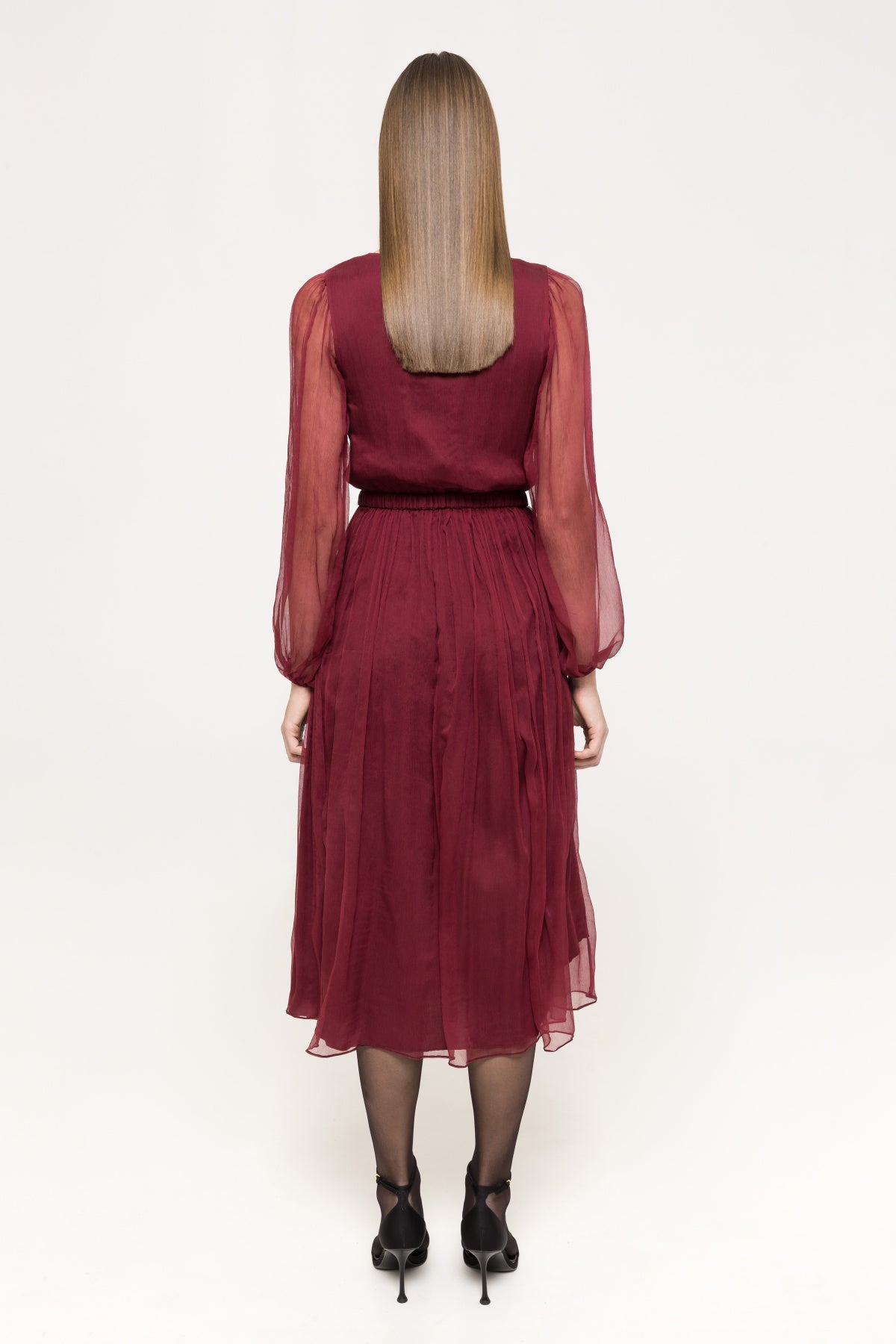 Back of burgundy midi dress with sheer sleeves and softly pleated skirt.