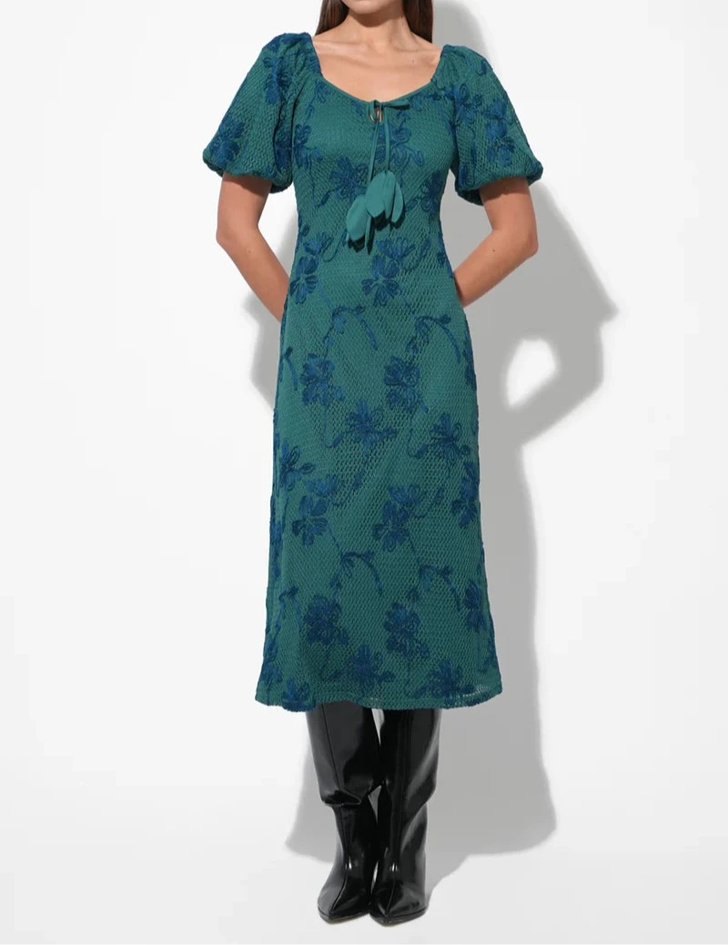 Front studio view of emerald teal floral knit midi with tassel ties and puff sleeves.